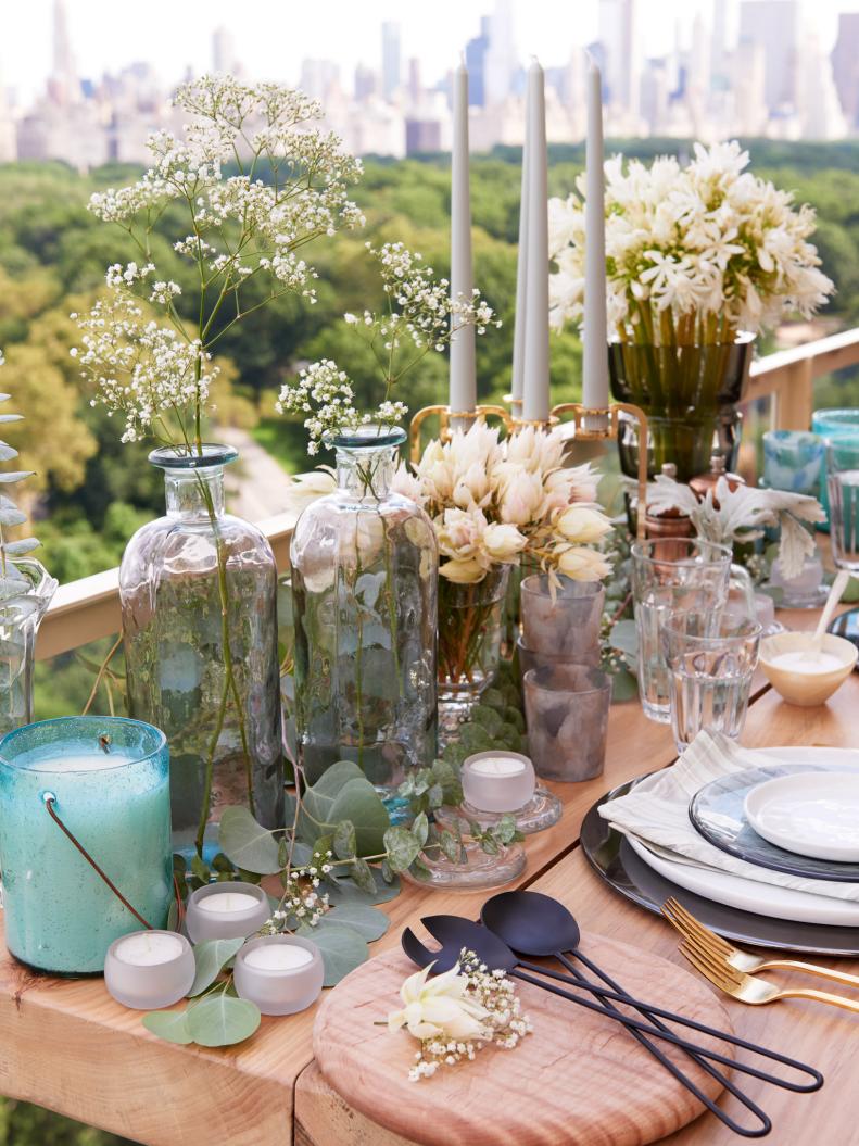 Plants and flowers add color, texture, and style to any tablescape, providing a natural yet unexpected centerpiece with their varying heights and containers.