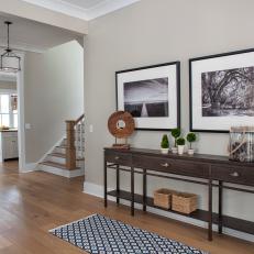 Foyer With Black-and-White Photos and Long Console Table