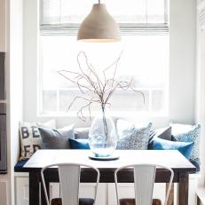 Breakfast Nook With Blue Banquette and Wooden Table