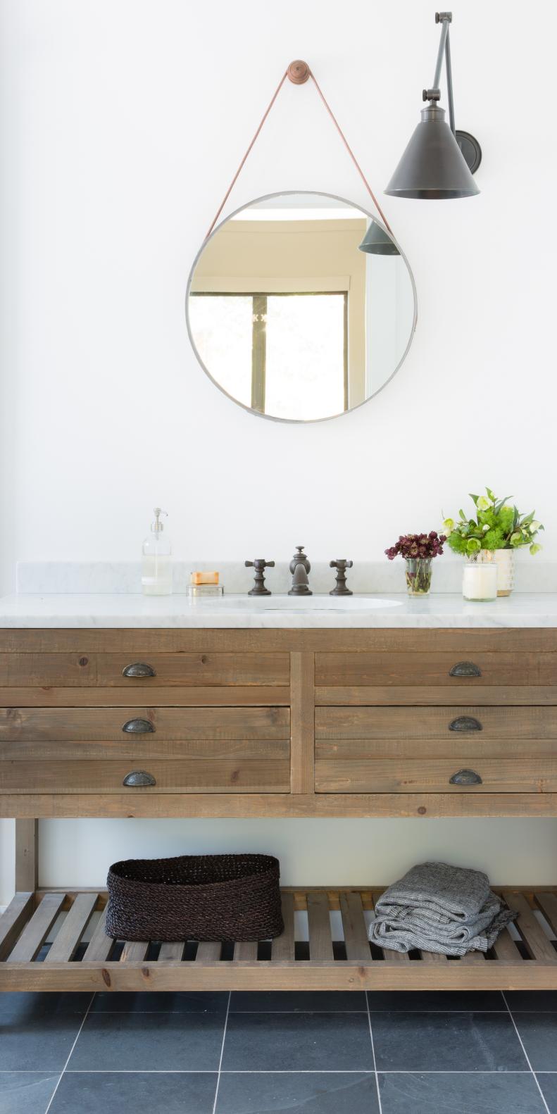 Rustic Wood Vanity With Round Mirror Hanging Above
