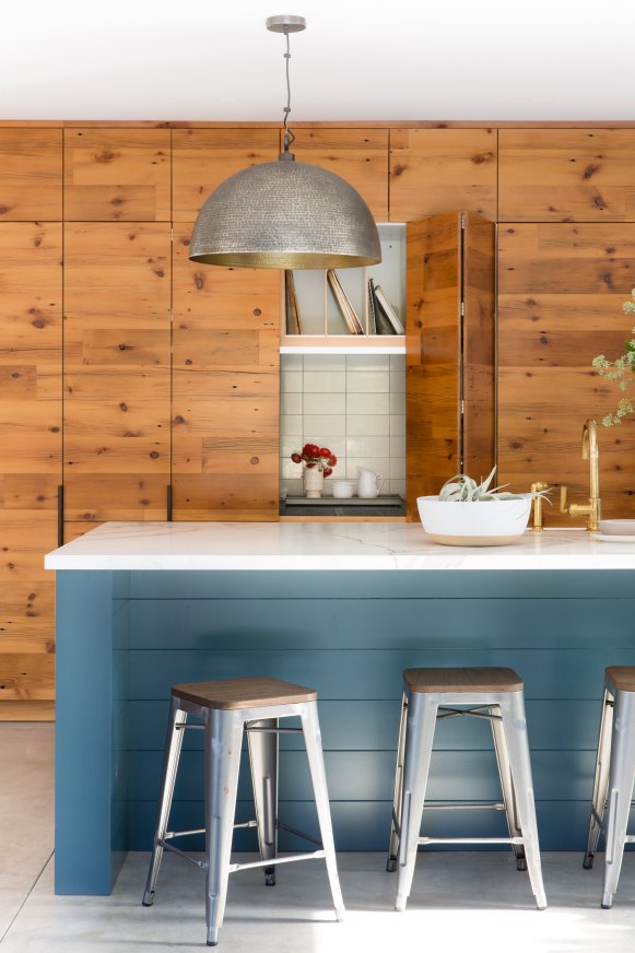 Blue Kitchen Island Lined With Barstools