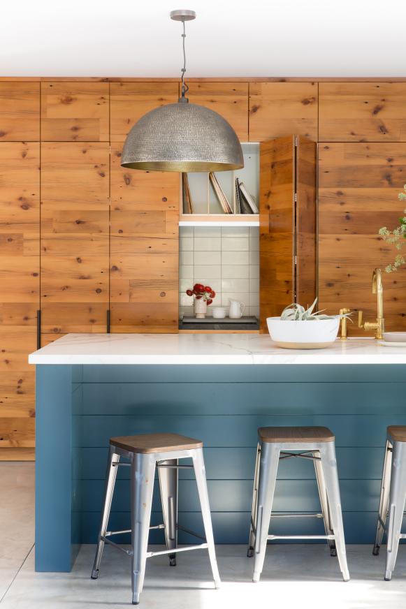 Blue Kitchen Island Lined With Barstools