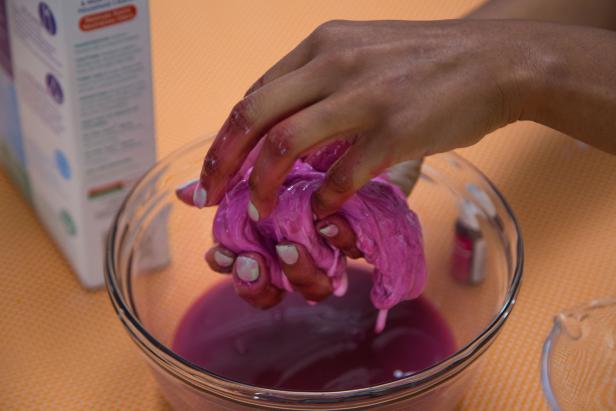 Stir as much as you can, then pick up the slime and begin to knead with your hands.