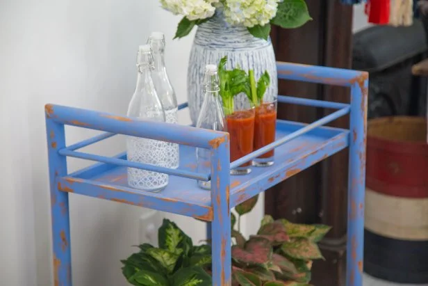 blue cart with plants and bottles