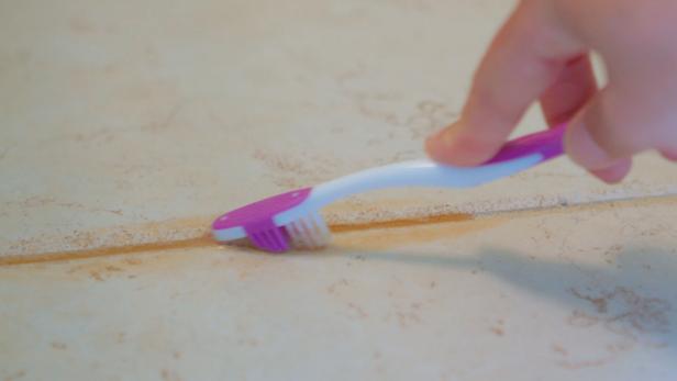 toothbrush scrubbing grout