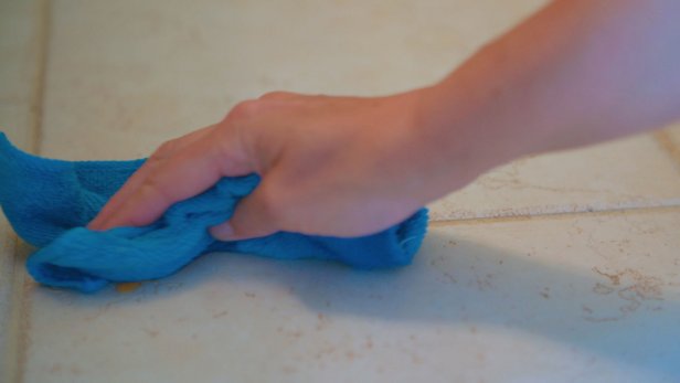 wiping tile with blue towel