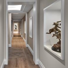 Art Gallery Inspired Hall With Display Shelves, Herringbone Floor Accent Pattern and White Molding