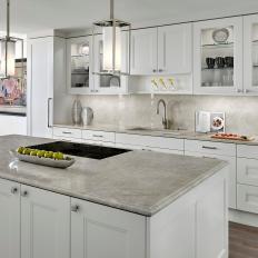 Transitional Kitchen Featuring Cabinet Backlighting, Neutral Quartzite and a Large Island