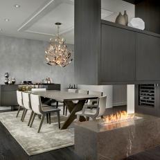 Gray Modern Dining Room With Stone Fire Table, Large Hanging Cabinet and Decorative Chandelier
