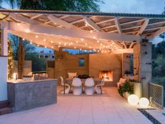 Bistro Lights, Fireplace Illuminate Outdoor Dining Space
