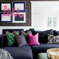 Blue Sectional With Colorful Pillows Beneath Graffiti Art
