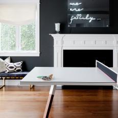 Contemporary Game Room With Black Walls and Ping Pong Table
