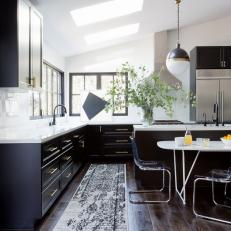 Kitchen With Skylights, Hardwood Floor and Black Cabinets