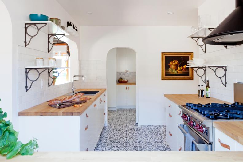 White Cottage Kitchen With Gas Range and Arched Door