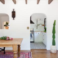 White Dining Room With Arched Door and Pass-Thru to Kitchen