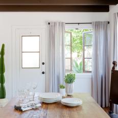 White Dining Room With Casement Window and Cactus Plant