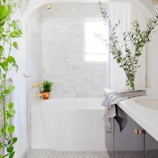 White Bathroom With Arch, Subway Tile and Mosaic Floor