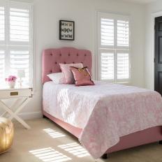 Kid's Bedroom With Pink Bed, White Shutters and Gold Pouf