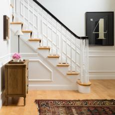 White Foyer With Chair Rail and Staircase With Spindles