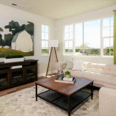 Living Room Area With White Sectional and Green Curtains