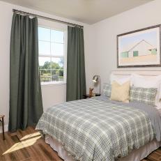 Country Guest Bedroom With Plaid Comforter and Wood Floor