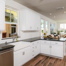 Country Kitchen With White Cabinets and Black Countertop