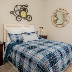Guest Bedroom With Blue Plaid Bed Linens and Clock Gear Art