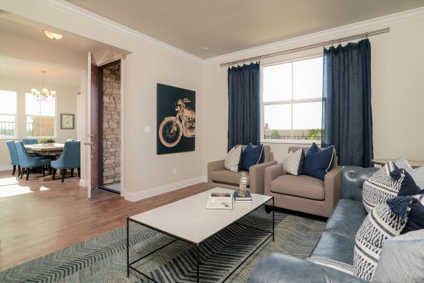 Living Room With Beige Chairs Blue Curtains And Chevron Rug Hgtv