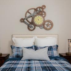 Guest Bedroom With Clock Gear Art and Blue Plaid Bed Linens