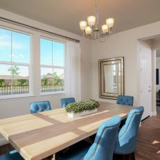 Dining Room With Light Wood Table and Blue Chairs