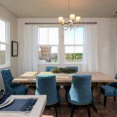 Transitional Dining Room With Blue Chairs, Light Wood Table