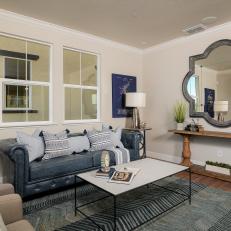 Living Room With Quatrefoil Mirror, Blue Sofa and Chevron Rug