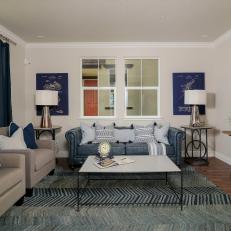 Living Room With Blue Sofa, Chevron Rug and Quatrefoil Mirror
