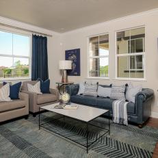 Living Room With Chevron Rug, Blue Sofa and Blueprint art