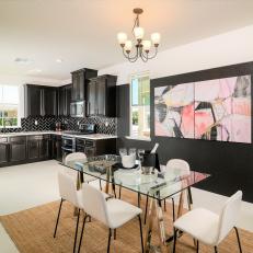 Black Kitchen and Dining Area With Large Pink Artwork
