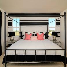 Master Suite With Iron Four-Poster Bed and Pink Accents