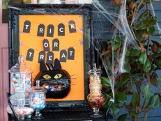 Transform the traditional pumpkin candy bowl on your porch into a decorative and creative statement piece. The black cat candy door hanger is easy to make, unique, and something the neighborhood kids will be so excited to try out.