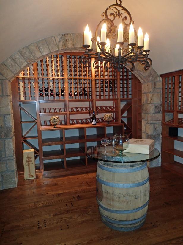 Rustic Wine Cavern with Custom Mahogany Wine Racks and Chandelier