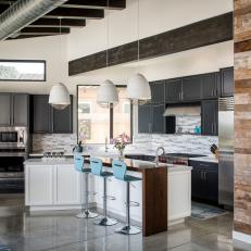 Industrial Open Kitchen With Blue Barstools