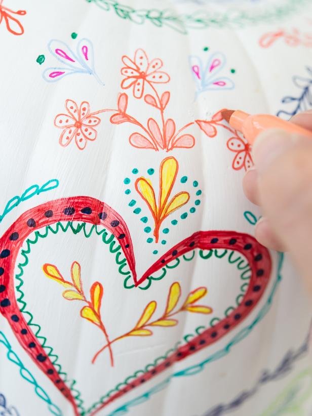Add more details and color to bring the designs to life.  Fill in outlines with a lighter shade of the same color.  Step back from pumpkin every few minutes to see if overall desired look is being achieved.