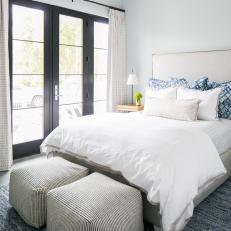 Black French Doors Bring in Natural Light to Warm This Neutral Bedroom Space