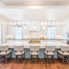 Open Kitchen With Upholstered White Barstools