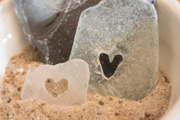 Use a rotary tool to cut hearts and designs into pieces of beach glass.