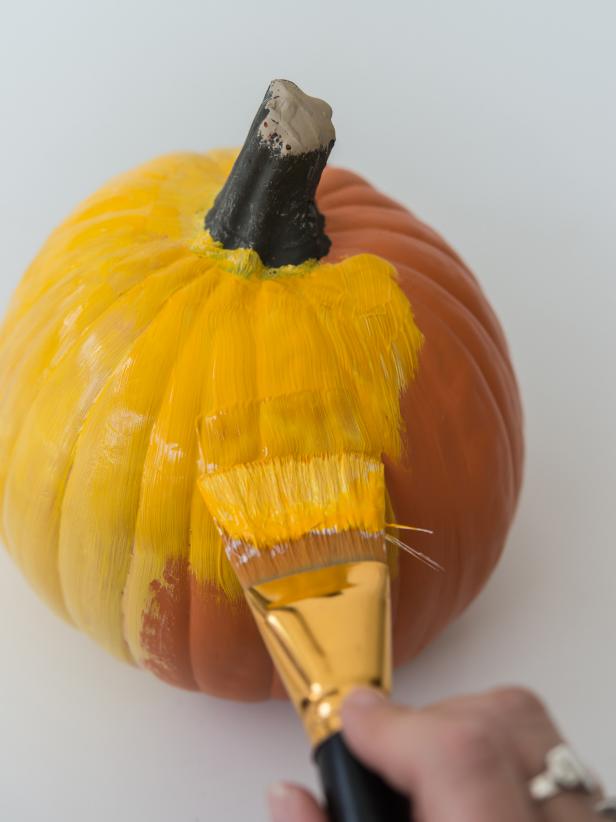 With a flat 1.5â   paint brush, apply acrylic craft paint to pumpkins.  Two coats may be required.  Allow pumpkins to dry completely.  Tip: Use colors that match the coloring of your pet to personalize this project!