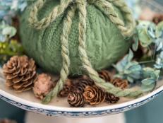 Cozy up a plain pumpkin with an old or thrifted sweater!  Itâ  ll bring amazing texture to any fall arrangement.