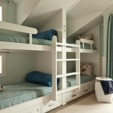 Blue and White Kid's Room With Four Bunk Beds