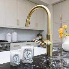 Gold Faucet and Candles in Kitchen