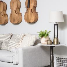 Traditional White Living Room with Wall-Mounted Cellos 