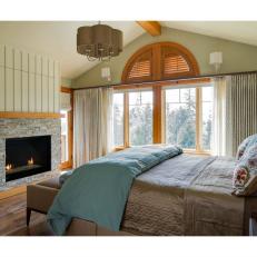 Green Rustic Bedroom With Stone Fireplace