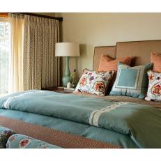 Beige Bed With Blue and Red Pillows